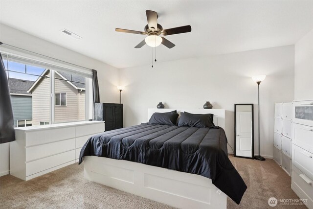 bedroom featuring ceiling fan, visible vents, baseboards, and carpet
