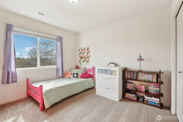 carpeted bedroom featuring baseboards and visible vents