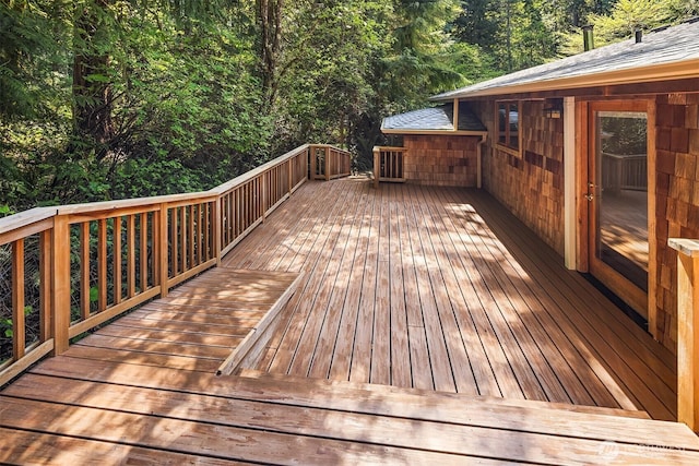 wooden terrace with a view of trees
