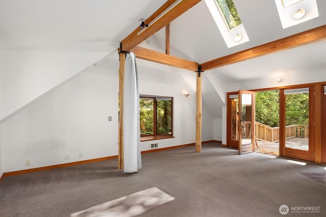 unfurnished living room featuring carpet flooring, a wealth of natural light, and lofted ceiling with skylight