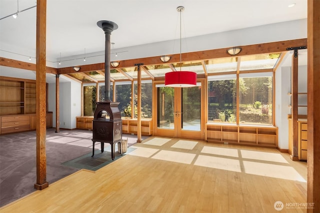 interior space featuring french doors and a wood stove