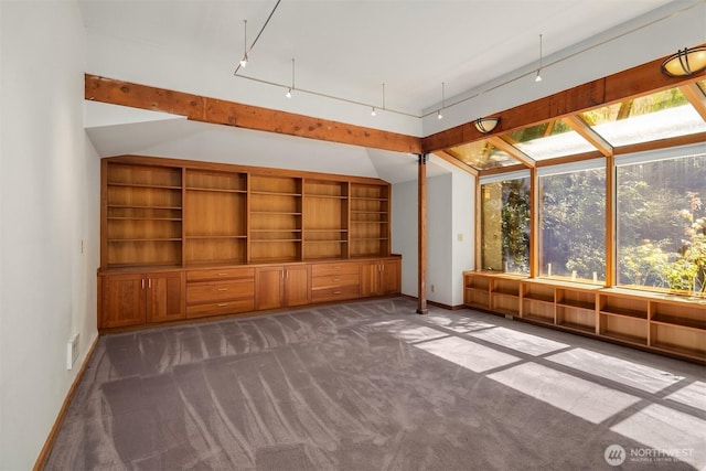 unfurnished room with baseboards and dark carpet