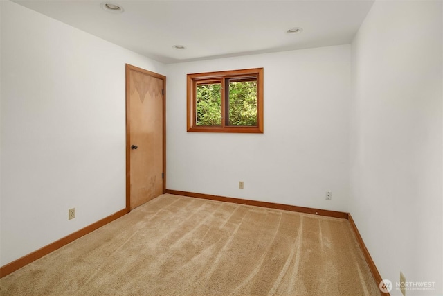 empty room with carpet floors, recessed lighting, and baseboards