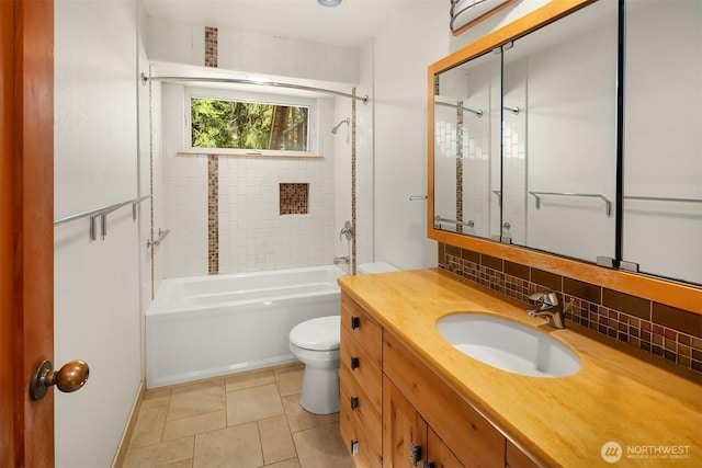full bath featuring vanity, toilet, tile patterned floors, decorative backsplash, and tub / shower combination