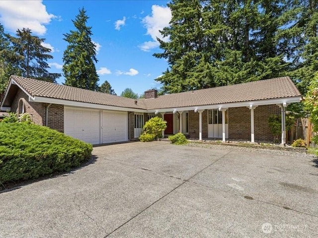 3616 SW 325th St, Federal Way, WA 98023 - ranch-style home with a tile roof, a garage, driveway, brick siding, and a chimney