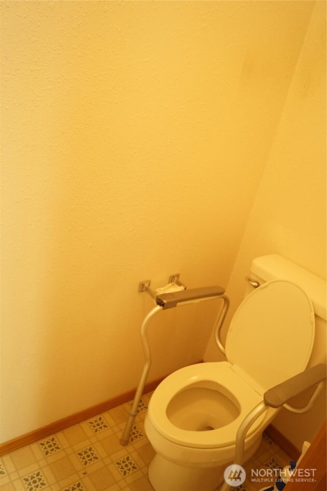 bathroom featuring toilet and baseboards