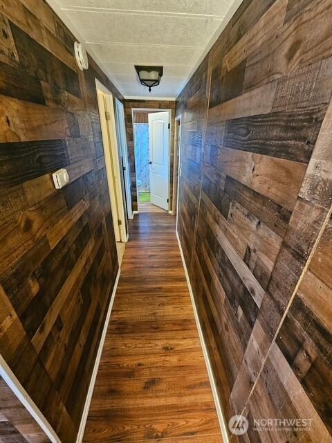 6505 Fawn Ln Unit 4, Long Beach, WA 98631 - hallway with wood walls and dark wood finished floors