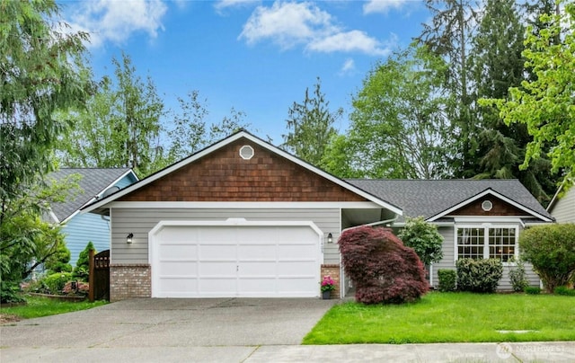 17406 Redhawk Dr, Arlington, WA 98223 - view of front of property featuring concrete driveway, brick siding, a garage, a front yard, and roof with shingles