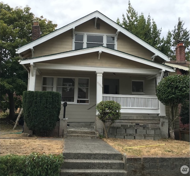 5011 8th Ave NE, Seattle, WA 98105 - bungalow-style house featuring covered porch and a chimney