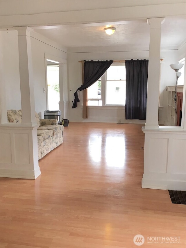 5011 8th Ave NE, Seattle, WA 98105 - interior space featuring decorative columns, visible vents, light wood-style floors, and a decorative wall