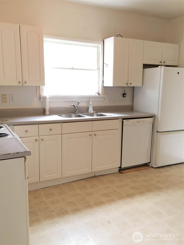 5011 8th Ave NE, Seattle, WA 98105 - kitchen featuring white cabinets, a sink, light floors, and white appliances