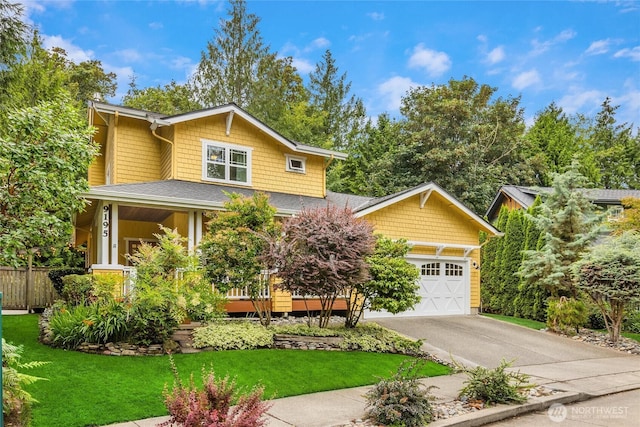 craftsman-style house featuring a shingled roof, a front lawn, fence, driveway, and an attached garage