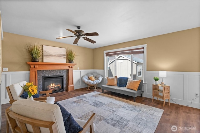 1625 185th Street Ct E, Spanaway, WA 98387 - living room with a wainscoted wall, a decorative wall, a glass covered fireplace, wood finished floors, and ceiling fan