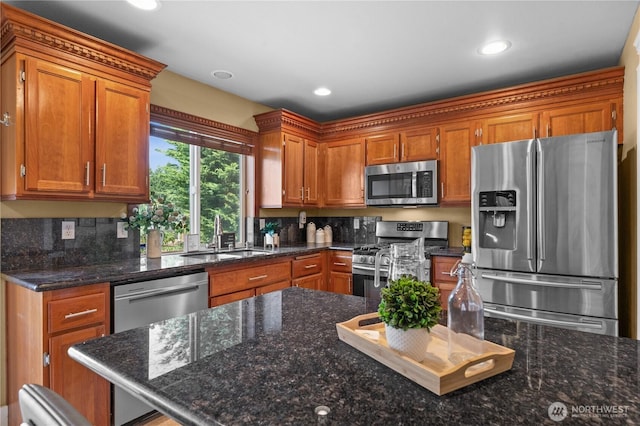 1625 185th Street Ct E, Spanaway, WA 98387 - kitchen with stainless steel appliances, brown cabinets, tasteful backsplash, recessed lighting, and dark stone countertops