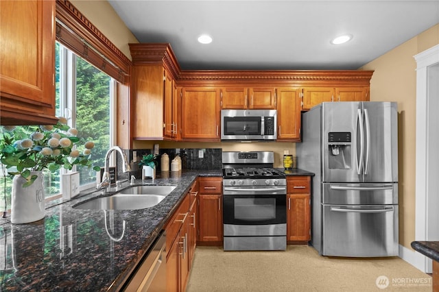 1625 185th Street Ct E, Spanaway, WA 98387 - kitchen with stainless steel appliances, brown cabinetry, dark stone countertops, and recessed lighting