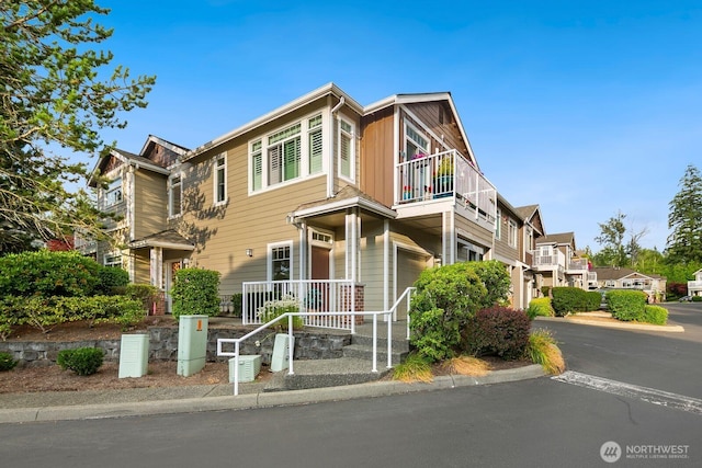 588 241st Ln SE, Sammamish, WA 98074 - view of property featuring a garage, board and batten siding, and a balcony