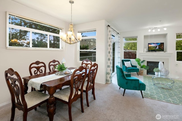 588 241st Ln SE, Sammamish, WA 98074 - carpeted dining area with a glass covered fireplace and a notable chandelier