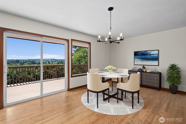 1918 SE Maple Dr, Chehalis, WA 98532 - dining room featuring a chandelier, light wood-type flooring, and baseboards