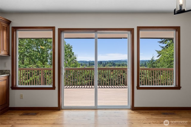 1918 SE Maple Dr, Chehalis, WA 98532 - doorway to outside featuring baseboards, light wood-type flooring, and healthy amount of natural light