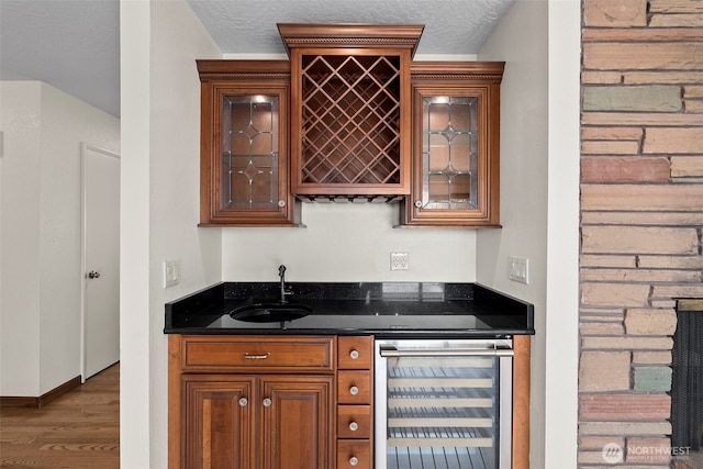 1918 SE Maple Dr, Chehalis, WA 98532 - indoor wet bar with wine cooler, wood finished floors, and a textured ceiling