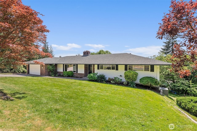 1918 SE Maple Dr, Chehalis, WA 98532 - ranch-style house featuring asphalt driveway, a garage, a front lawn, and a chimney