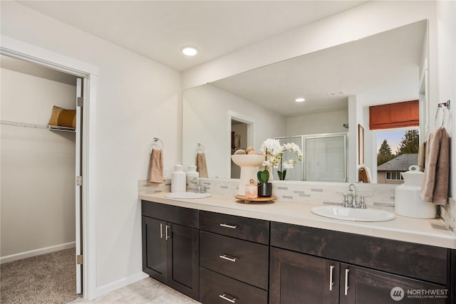 1133 68th Ave SE, Tumwater, WA 98501 - full bath featuring double vanity, a spacious closet, a stall shower, and a sink
