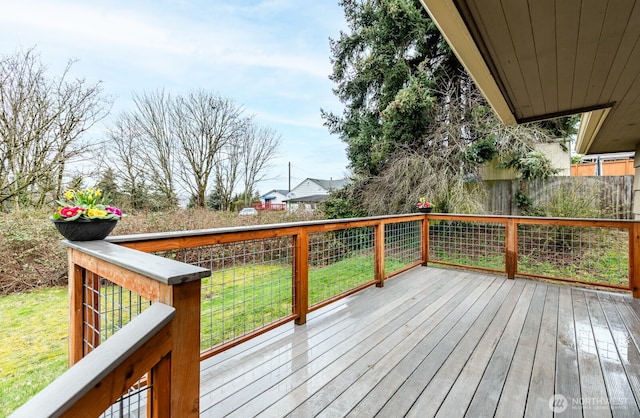 wooden terrace featuring a lawn