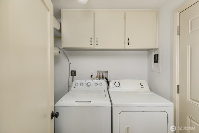 clothes washing area with cabinet space and washer and clothes dryer