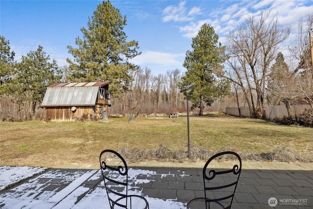view of yard featuring an outdoor structure and fence