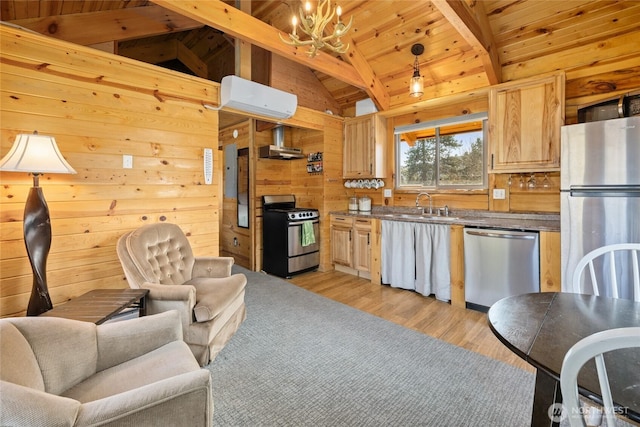 kitchen featuring appliances with stainless steel finishes, wall chimney exhaust hood, wood walls, an inviting chandelier, and vaulted ceiling with beams