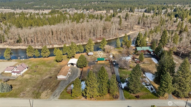 aerial view with a water view and a wooded view