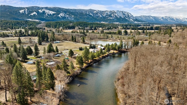 drone / aerial view with a water and mountain view