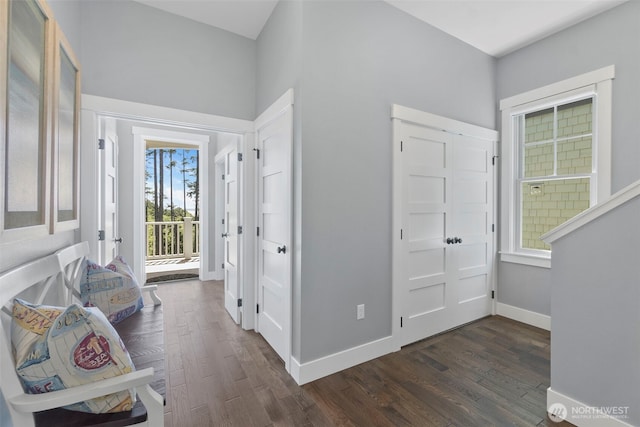 entrance foyer with baseboards and dark wood-style flooring