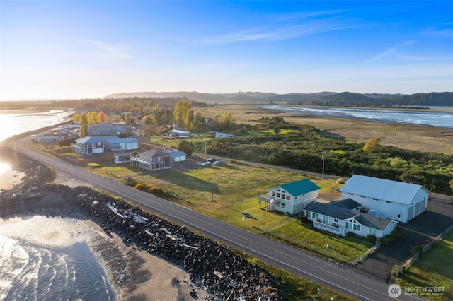 birds eye view of property with a water and mountain view