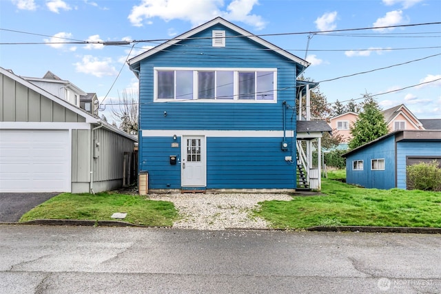 160 Maple St, Cathlamet, WA 98612 - view of front of house with stairway, a garage, and a front yard