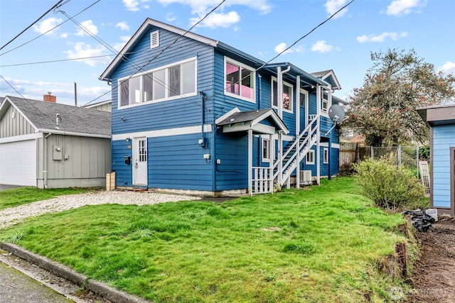 160 Maple St, Cathlamet, WA 98612 - view of side of home featuring a detached garage, fence, stairs, a yard, and an outbuilding