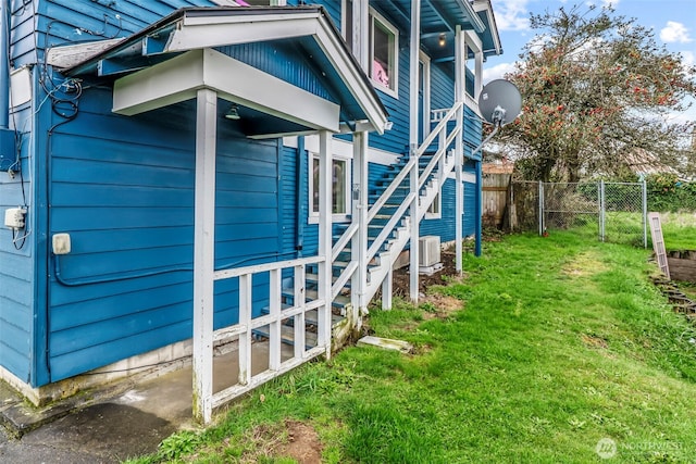 160 Maple St, Cathlamet, WA 98612 - view of side of property featuring central AC unit, stairway, a yard, and fence