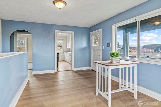 160 Maple St, Cathlamet, WA 98612 - foyer with a textured ceiling, wood finished floors, arched walkways, and baseboards