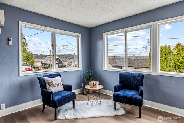 160 Maple St, Cathlamet, WA 98612 - sitting room featuring a textured ceiling, baseboards, and wood finished floors