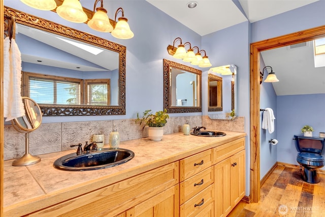 21401 161st Ave E, Graham, WA 98338 - full bath featuring tasteful backsplash, vaulted ceiling, wood finished floors, and a sink