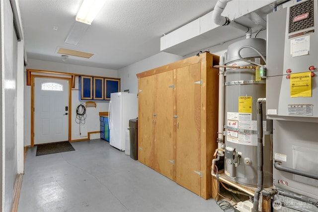 21401 161st Ave E, Graham, WA 98338 - below grade area featuring secured water heater, freestanding refrigerator, and a textured ceiling