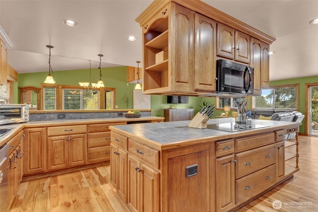 21401 161st Ave E, Graham, WA 98338 - kitchen featuring light wood finished floors, tile counters, a chandelier, pendant lighting, and black appliances