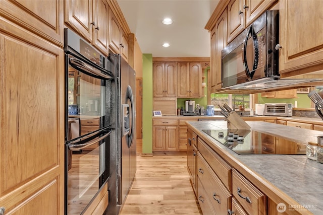 21401 161st Ave E, Graham, WA 98338 - kitchen with light brown cabinetry, a toaster, recessed lighting, light wood-style flooring, and black appliances
