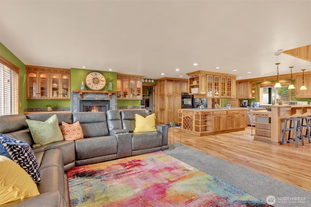 21401 161st Ave E, Graham, WA 98338 - living room with a wealth of natural light, light wood-type flooring, a warm lit fireplace, and recessed lighting