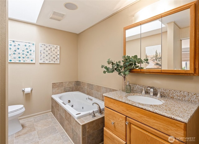 bathroom featuring visible vents, a jetted tub, baseboards, toilet, and vanity