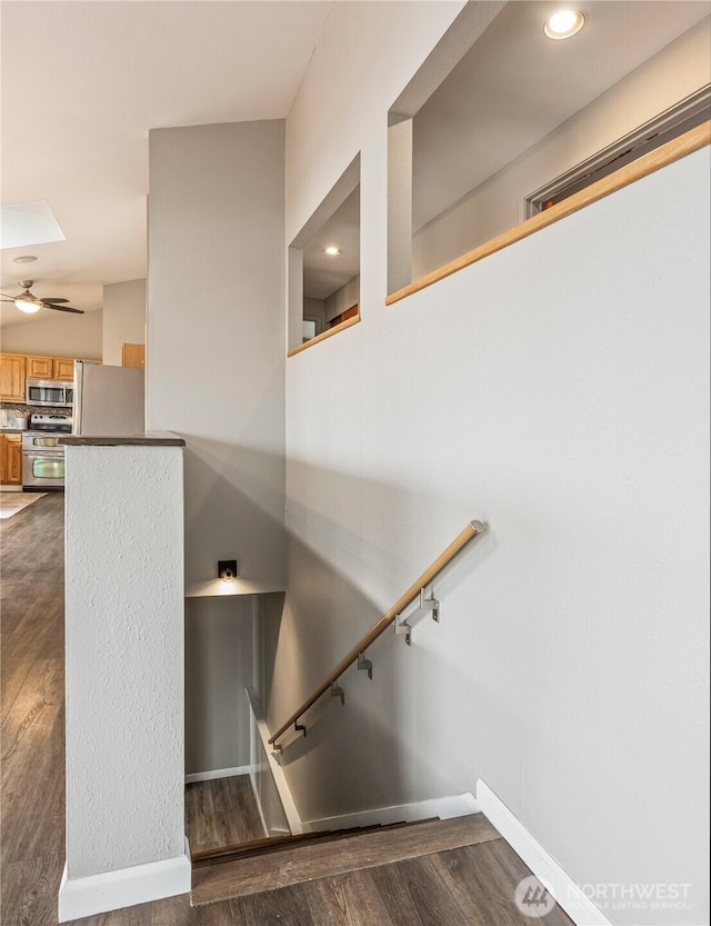 stairs featuring recessed lighting, baseboards, wood finished floors, and a ceiling fan