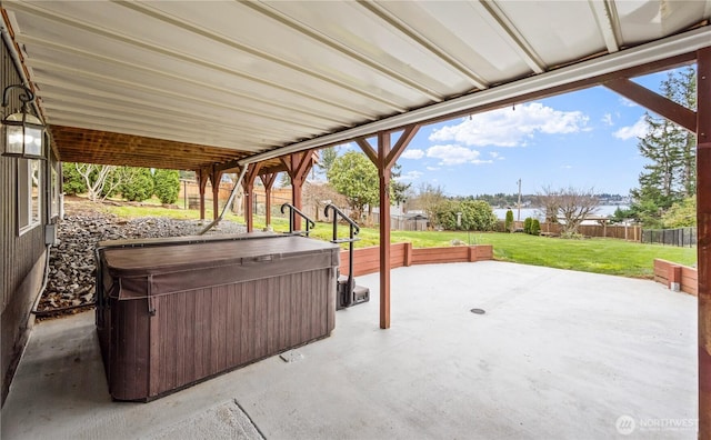 view of patio / terrace with a fenced backyard and a hot tub