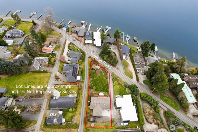drone / aerial view with a residential view and a water view
