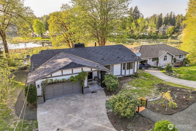 10231 Kiwa Dr SE, Olympia, WA 98513 - view of front of property with an attached garage, concrete driveway, and stucco siding
