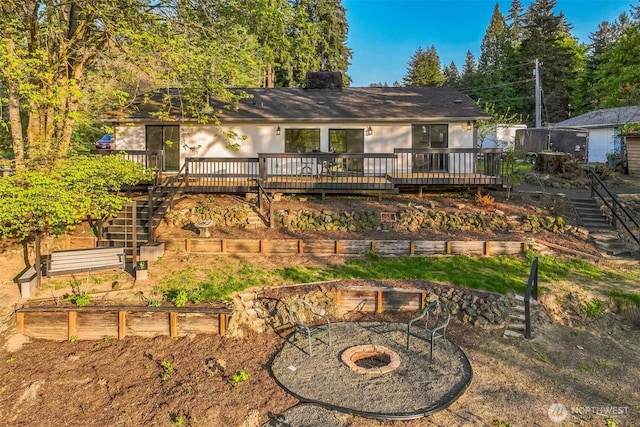 10231 Kiwa Dr SE, Olympia, WA 98513 - rear view of property with an outdoor fire pit, stairs, a wooden deck, and a garden